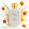 A bottle of Loui Martin Latte Blanc perfume is shown with splashes of milk and caramel cubes. Anteprima dell’immagine prodotto