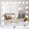 A makeup mirror with lights is displayed on a white surface, reflecting a room with a chair, a lamp, and a teddy bear. Produktbild-Vorschau
