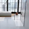 A modern bathroom with a large window overlooking a city skyline, featuring a bathtub and a shower tray. Produktbild-Vorschau