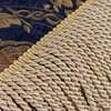 A close-up view of a textile with a decorative pattern and fringe. Produktbild-Vorschau