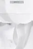 A close-up view of a white shirt, focusing on the collar and a label. Produktbild-Vorschau