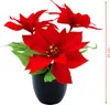 A potted artificial poinsettia plant with red flowers and green leaves. Voir les images du produit