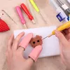 A person is using a needle felting kit to create a small brown animal figure. The kit includes various tools and materials for felting. Produktbild-Vorschau