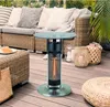 An outdoor patio scene with a heater table, seating, and decorative items. Produktbild-Vorschau