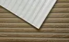A close-up view of two textured surfaces, one resembling wood grain and the other a ribbed white material, overlapping each other. Náhled obrázku produktu