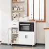 A white kitchen sideboard with a microwave, coffee machine, and storage cabinets, set against a light gray wall and a window with blinds. Anteprima dell’immagine prodotto