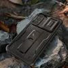 A black phone case with a kickstand is placed on rocks and leaves. Náhľad obrázku produktu