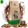A bag of coffee beans with chocolate and hazelnuts, surrounded by splashes of milk and chocolate. Produktbild-Vorschau