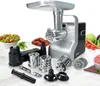A meat grinder and its accessories are displayed on a marble surface with fresh ingredients in the background. Anteprima dell’immagine prodotto