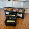 A black thermal printer and a wooden tea box are placed on a wooden countertop. Podgląd zdjęcia produktu