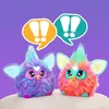 Two colorful, fluffy toys with large eyes and pointed ears are positioned side-by-side against a purple background. Above them are two speech bubbles with exclamation marks, suggesting communication or excitement. Podgląd zdjęcia produktu