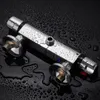 A chrome shower thermostat with water droplets on a black, wet surface. Produktbild-Vorschau