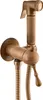A close-up studio shot of a vintage-style bidet sprayer and faucet. Podgląd zdjęcia produktu