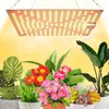 A grow light suspended above a collection of potted plants.