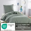 A bed with green bedding, styled in a bedroom setting. Náhľad obrázku produktu