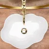 A top-down view of a white, cloud-shaped vessel sink with a gold faucet. Produktbild-Vorschau