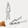 Two silver nutcrackers, one shaped like a Christmas tree, and a few nuts are shown against a white background. Produktbild-Vorschau