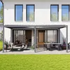 A modern house with a patio covered by a pergola, furnished with outdoor seating and a dining set. Voir les images du produit