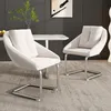 Two beige dining chairs with silver metal frames are placed in a dining room setting. Náhľad obrázku produktu