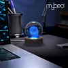 A glowing crystal ball with a planet inside sits on a wooden base on a desk next to a laptop and a cup of pens. Voir les images du produit