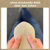 A person is holding a beige sock, showing the toe area. Produktbild-Vorschau