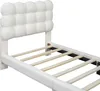 A close-up view of a white upholstered bed frame and headboard, showing the wooden slats of the bed base. Produktbild-Vorschau