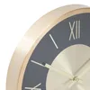 A close-up view of a modern wall clock with a gold frame and a dark gray face. Podgląd zdjęcia produktu