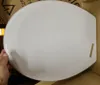 A person's hand is holding a white toilet seat lid inside a cardboard box. Podgląd zdjęcia produktu