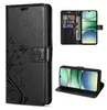 A collage of images showing a black leather flip phone case with a floral design, a phone inside the case, and the case in a stand position. Produktbild-Vorschau