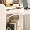 A close-up view of a white shelf unit with books and a laptop. Podgląd zdjęcia produktu