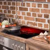 A kitchen counter with a stovetop and backsplash. Náhled obrázku produktu
