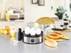 An egg cooker with eggs and breakfast rolls on a kitchen counter. Produktbild-Vorschau