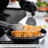 A person in black gloves is cooking salmon fillets in a pan. Náhled obrázku produktu