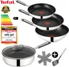 A stack of Tefal frying pans and a saucepan with a lid, along with some accessories and marketing labels. Produktbild-Vorschau