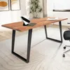 A wooden desk with black metal U-shaped legs in a home office setting. Voir les images du produit