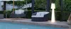 An outdoor lounge area with a pool, seating, and a floor lamp. Produktbild-Vorschau