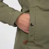 A close-up shot of a person's hand in the pocket of a green jacket. Produktbild-Vorschau