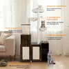 A multi-level cat tree with integrated cat toilet and feeding station, set up in a living room environment. Voir les images du produit