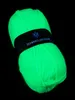 A ball of neon green yarn on a black background. Produktbild-Vorschau