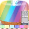 A rainbow-colored aroma diffuser with a remote control and several smaller diffusers in different colors shown in the foreground. Anteprima dell’immagine prodotto