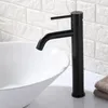 A black faucet is shown above a white sink, with a white brick wall in the background. Anteprima dell’immagine prodotto