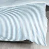 A close-up view of striped bedding. Produktbild-Vorschau