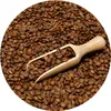 A close-up view of roasted coffee beans with a wooden scoop. Produktbild-Vorschau