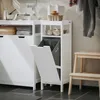 A laundry room scene with a white cabinet, a laundry sorter with a basket, and a wooden step stool. Produktbild-Vorschau