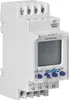 A close-up, angled view of a white electronic timer device with a digital display and blue buttons, mounted on a DIN rail. Náhled obrázku produktu
