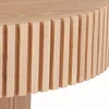 A close-up view of the side of a round wooden table with vertical slats. Produktbild-Vorschau