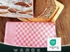 A loaf of bread and sliced bread are placed on a wooden board, with a red and white checkered tea towel in the foreground. A certification logo is visible in the bottom right corner. Produktbild-Vorschau