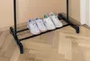 A shoe rack with four pairs of shoes on it, placed on a wooden floor. Náhled obrázku produktu