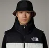 A person wearing a bucket hat and a puffer vest. Produktbild-Vorschau