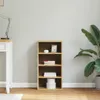 A wooden bookshelf with items on its shelves, placed next to a desk and a large plant. Podgląd zdjęcia produktu